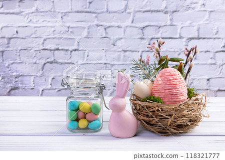 Easter nest with eggs and branches, bunny and jar with candies. Easter nest with eggs and branches, bunny and jar with candies. 118321777