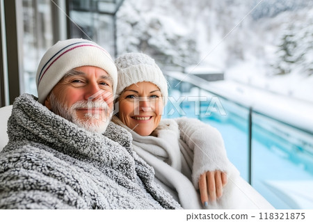 Happy senior couple in winter clothes sitting on the terrace of the hotel room. Happy senior couple in winter clothes sitting on the terrace of the hotel room. 118321875
