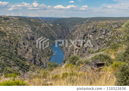 Rugged Cliffs Over Serene River in Pristine Wilderness 118322636