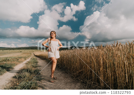 Woman in a White Dress Standing on a Dirt Road 118322793