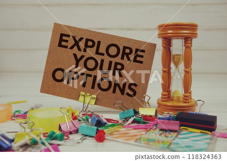 Explore Your Options text on paper card with hourglass and stationary on wooden background Explore Your Options text on paper card with hourglass and stationary on wooden background 118324363