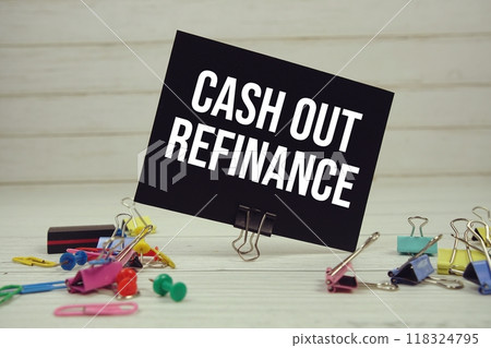Cash Out Refinance text on paper card with stationary on wooden background 118324795