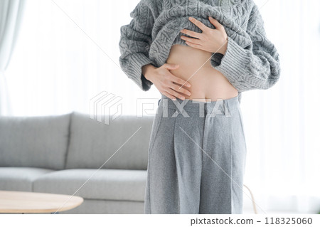 Woman touching her stomach 118325060