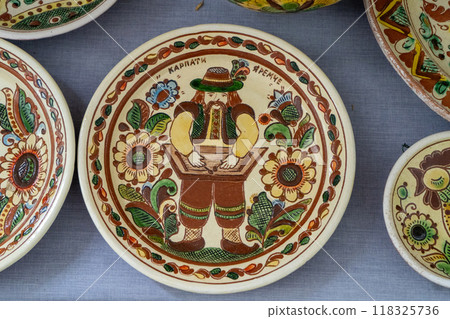 Ukrainian plates dishes. Clay ceramics food. Kosiv painting. Ukrainian plates dishes. Clay ceramics food. Kosiv painting. 118325736