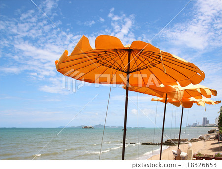 Yellow beach umbrella on blue sky and white clouds Yellow beach umbrella on blue sky and white clouds 118326653