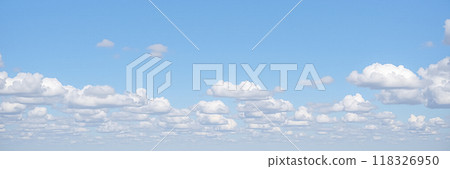 Panoramic sky banner with fluffy white clouds on blue background, serene daytime cloudscape, wide open atmosphere for calm design Panoramic sky banner with fluffy white clouds on blue background, serene daytime cloudscape, wide open atmosphere for calm design 118326950