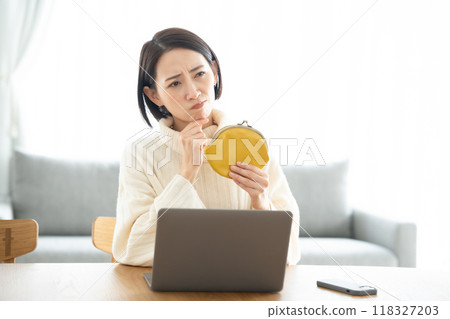 A woman having trouble holding a wallet A woman having trouble holding a wallet 118327203