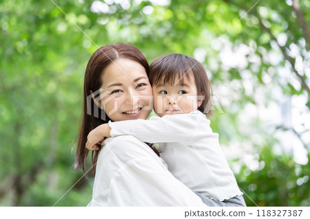 媽媽抱著她的女兒，新鮮的綠色 118327387