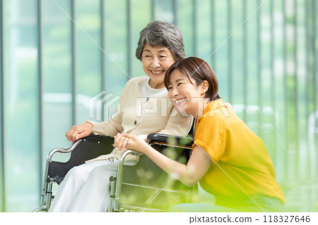 Senior woman in a wheelchair and young woman caring for her 118327646