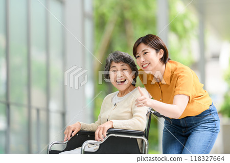 Senior woman in a wheelchair and young woman caring for her 118327664