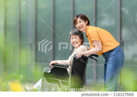 Senior woman in a wheelchair and young woman caring for her 118327666