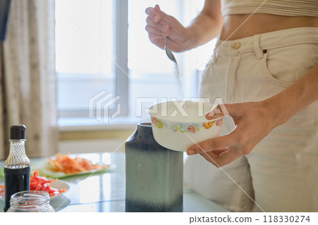 Preparing a light meal with fresh ingredients in a bright kitchen during the day Preparing a light meal with fresh ingredients in a bright kitchen during the day 118330274