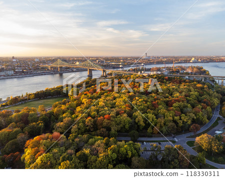 Aerial view of Jean-Drapeau Park, Saint Helen's Island in autumn sunset time. St. Lawrence River, Jacques Cartier Bridge in the background. Montreal, Quebec, Canada. Aerial view of Jean-Drapeau Park, Saint Helen's Island in autumn sunset time. St. Lawrence River, Jacques Cartier Bridge in the background. Montreal, Quebec, Canada. 118330311