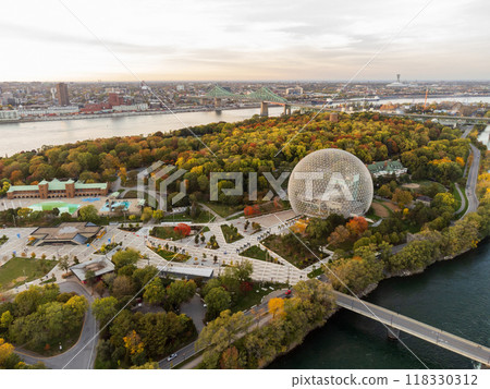 Aerial view of Montreal Biosphere in autumn sunset time. St. Lawrence River, Jacques Cartier Bridge in the background. Jean-Drapeau Park, Saint Helen's Island, Montreal, Quebec, Canada. 118330312
