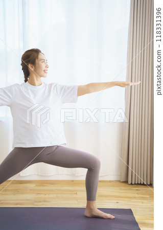 A young woman delivering an online yoga salon A young woman delivering an online yoga salon 118331396