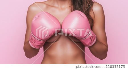 Woman wearing pink boxing gloves for breast cancer awareness 118332175