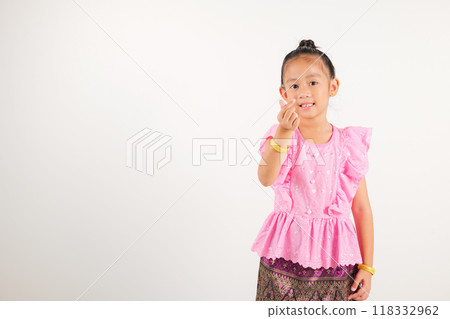 Portrait Thailand kid girl smiling traditional Thai dress costume showing mini heart sign with finger, studio isolated white background, kindergarten child expressing love and joy for Valentine Day 118332962