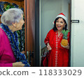 Combating Loneliness at Christmas: Social Worker's Festive Approach Brings Joy to Elderly Woman's Home. 118333029