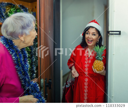 Combating Loneliness at Christmas: Social Worker's Festive Approach Brings Joy to Elderly Woman's Home. 118333029