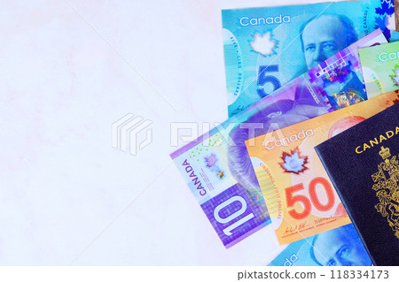 Passport issued by Canadian government with Canada banknotes in currency dollars in cash of various denominations Passport issued by Canadian government with Canada banknotes in currency dollars in cash of various denominations 118334173