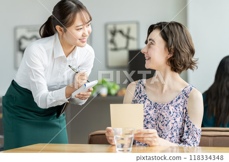 為外國遊客服務的年輕女服務員 為外國遊客服務的年輕女服務員 118334348