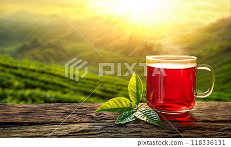 Red tea in glass cup, tea plantation at sunset in the background, copy space, hight detailed upscaled image 118336131