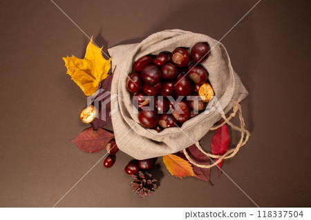 Fresh chestnuts in linen bag on the brown background. 118337504