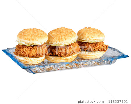 Fourth of July picnic fried chicken and biscuit sandwiches served on a transparent glass dish Fourth of July picnic fried chicken and biscuit sandwiches served on a transparent glass dish 118337591