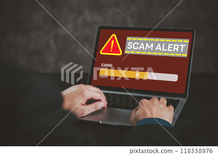 Laptop screen displaying scam alert warning. Highlights cybersecurity, online fraud, digital risk awareness. Suitable for tech security, internet safety topics. Laptop screen displaying scam alert warning. Highlights cybersecurity, online fraud, digital risk awareness. Suitable for tech security, internet safety topics. 118338976