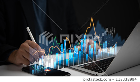 businessman digital chart displayed above a smartphone and laptop. stock market graph, trading, economic growth financial data trends, analysis and planning. 118338994