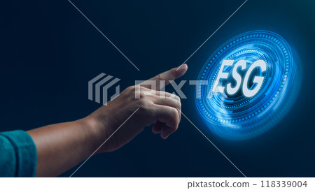 A hand reaching out to a futuristic, glowing ESG symbol, symbolizing the integration of Environmental, Social, and Governance principles in modern business practices. 118339004