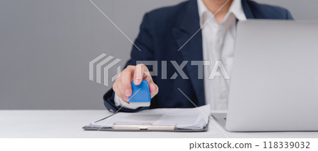 Hand stamping a document, approval and verification in a business setting.official procedures and corporate paperwork. business articles, office management and administrative resources. 118339032