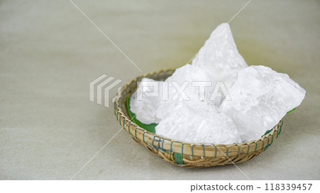 White crystal clear alum cube on brown background The chemical compound substance concept of spa and beauty industry. White crystal clear alum cube on brown background The chemical compound substance concept of spa and beauty industry. 118339457