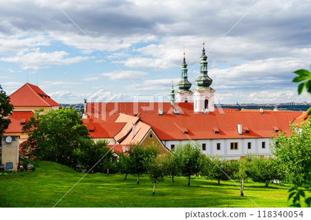 Historic red roof monastery building with garden full of green trees and lawn Historic red roof monastery building with garden full of green trees and lawn 118340054
