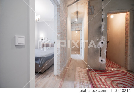 Photo collage of hallway and bedroom before and after refurbishment. Old apartment with underfloor heating pipes and new renovated flat with bed, doorway, elegant interior design. Focus on the switch. 118340215