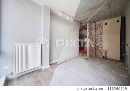 Empty living room with installed heating system before and after restoration. Comparison of old apartment and new renovated flat with parquet floor, radiator and white wall. Home renovation concept. Empty living room with installed heating system before and after restoration. Comparison of old apartment and new renovated flat with parquet floor, radiator and white wall. Home renovation concept. 118340219