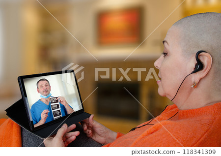 Patient receives breast cancer consultation via tablet as doctor explains ultrasound results remotely, illustrating modern healthcare communication. 118341309