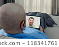 Remote therapy session: cancer patient connects with psychologist via tablet, illustrating the importance of mental health in treatment. 118341761