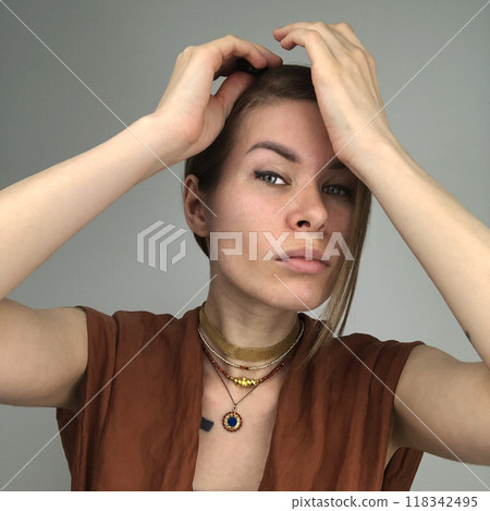 Portrait of a young woman in unusual massive jewelry 118342495