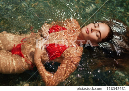 Happy woman sea relaxing floating in transparent sea water on summer holiday. Travel leisure recreation lifestyle, female in nature. Happy woman sea relaxing floating in transparent sea water on summer holiday. Travel leisure recreation lifestyle, female in nature. 118342681