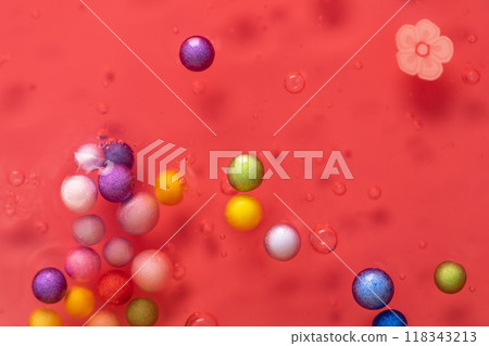 Colorful gel texture, clear skincare cream with bubbles and decorative figurines background, transparent beauty serum, colored cosmetic product close up Colorful gel texture, clear skincare cream with bubbles and decorative figurines background, transparent beauty serum, colored cosmetic product close up 118343213