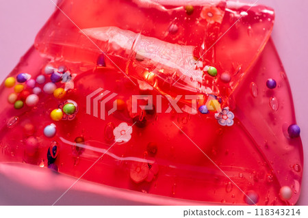 Colorful gel texture, clear skincare cream with bubbles and decorative figurines background, transparent beauty serum, colored cosmetic product close up Colorful gel texture, clear skincare cream with bubbles and decorative figurines background, transparent beauty serum, colored cosmetic product close up 118343214