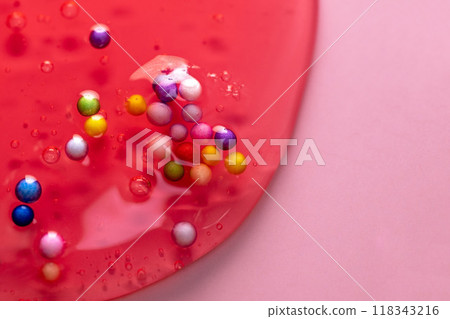 Colorful gel texture, clear skincare cream with bubbles and decorative figurines background, transparent beauty serum, colored cosmetic product close up Colorful gel texture, clear skincare cream with bubbles and decorative figurines background, transparent beauty serum, colored cosmetic product close up 118343216