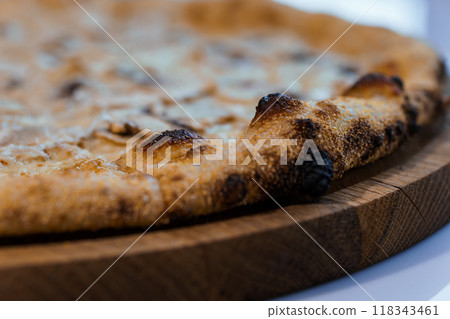 Close-Up of Deliciously Golden Crust Artisan Cheese Pizza on Wooden Board Close-Up of Deliciously Golden Crust Artisan Cheese Pizza on Wooden Board 118343461