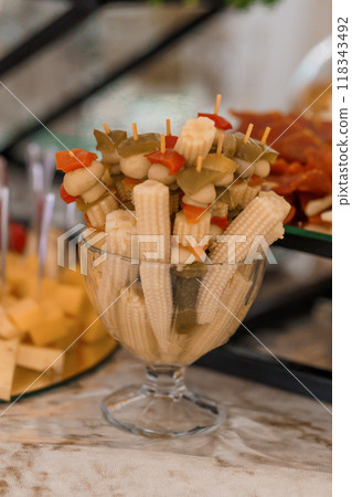 Elegant Display of Colorful Vegetable Skewers in Glass Dish at Gourmet Event 118343492