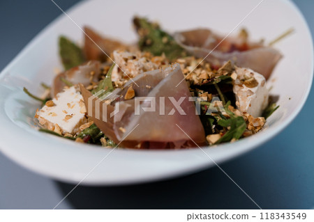 Gourmet Salad with Prosciutto, Goat Cheese, and Mixed Greens in Elegant White Bowl Gourmet Salad with Prosciutto, Goat Cheese, and Mixed Greens in Elegant White Bowl 118343549