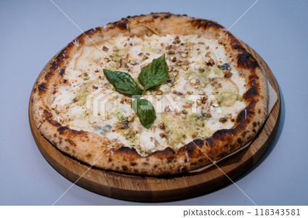 Gourmet Nutty Delight Pizza with Fresh Basil on Wooden Board Gourmet Nutty Delight Pizza with Fresh Basil on Wooden Board 118343581