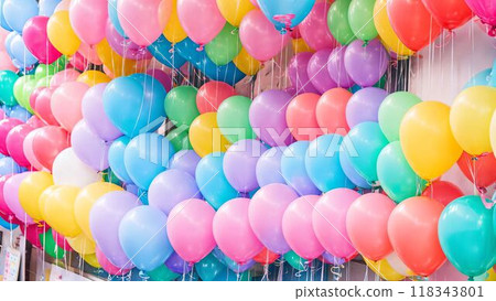 Many balloons lined up outside 118343801