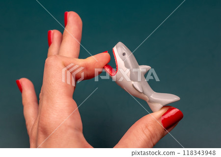 Shark bites a woman's hand with red nails, shark attack on human Shark bites a woman's hand with red nails, shark attack on human 118343948