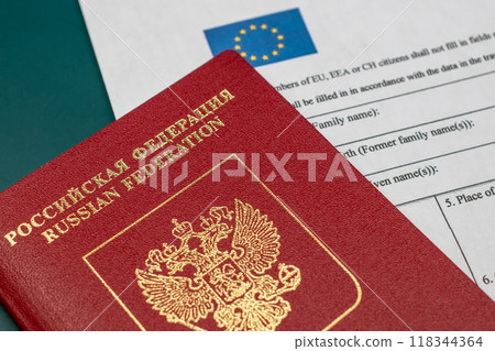 Russian travel passport with Schengen visa application form, sanctions, emigration, immigration, tourism concept 118344364